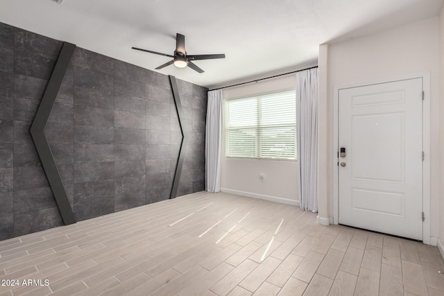 unfurnished room featuring light hardwood / wood-style flooring and ceiling fan