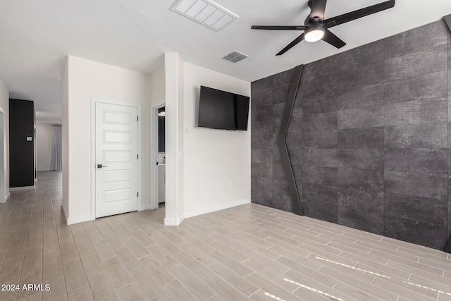 spare room featuring light hardwood / wood-style floors and ceiling fan