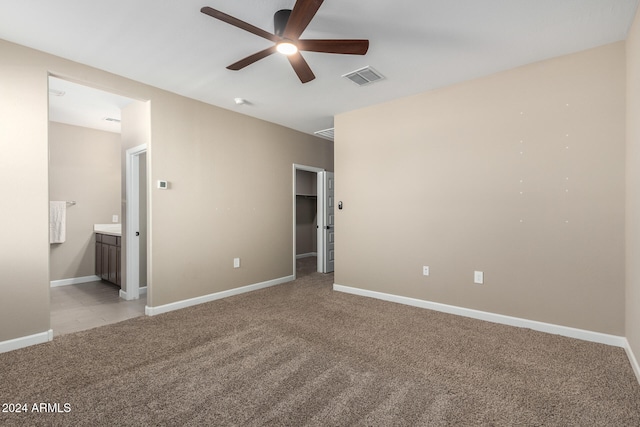 spare room with light colored carpet and ceiling fan