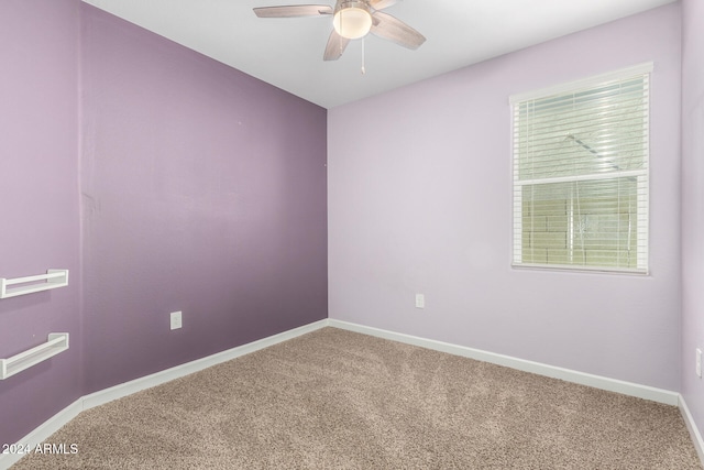 spare room featuring carpet and ceiling fan