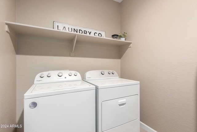 clothes washing area featuring washer and clothes dryer