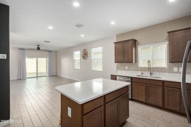 kitchen featuring a center island, a healthy amount of sunlight, appliances with stainless steel finishes, and sink