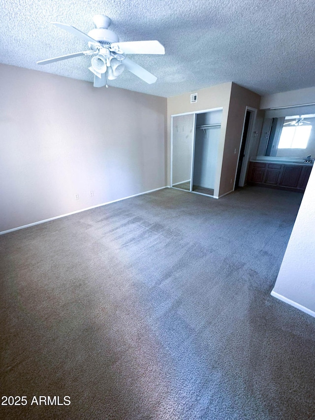 1075 E Chandler Blvd Unit 220, Chandler, AZ 85225 - unfurnished bedroom with carpet, a textured ceiling, baseboards, and ceiling fan