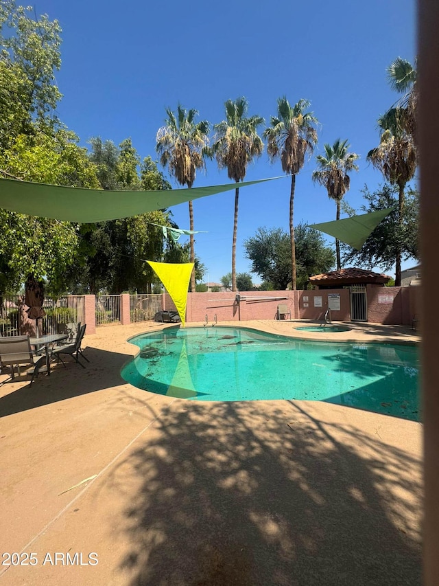 1075 E Chandler Blvd Unit 220, Chandler, AZ 85225 - view of swimming pool featuring a patio