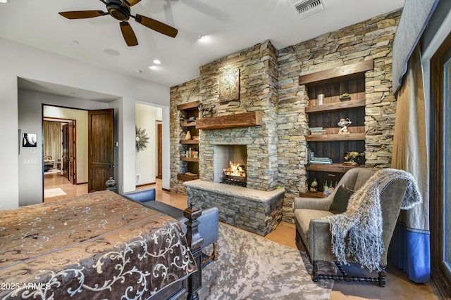 bedroom with ceiling fan and a fireplace