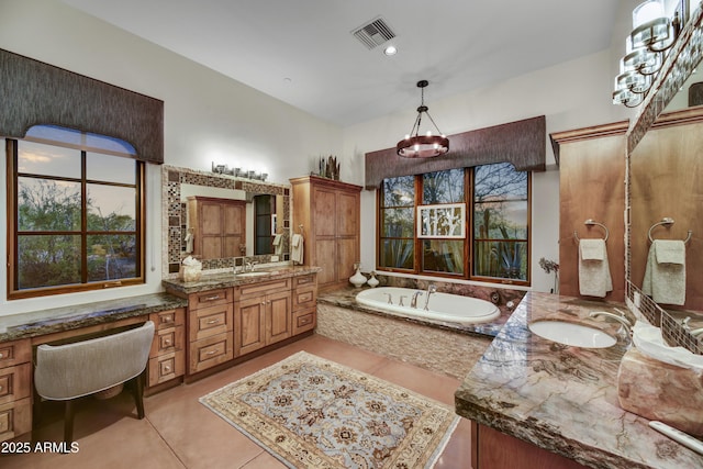 bathroom with vanity, tiled bath, and tile patterned floors