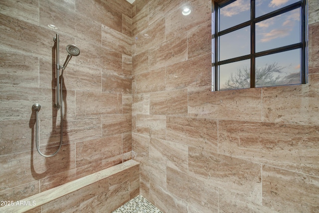 bathroom with a tile shower