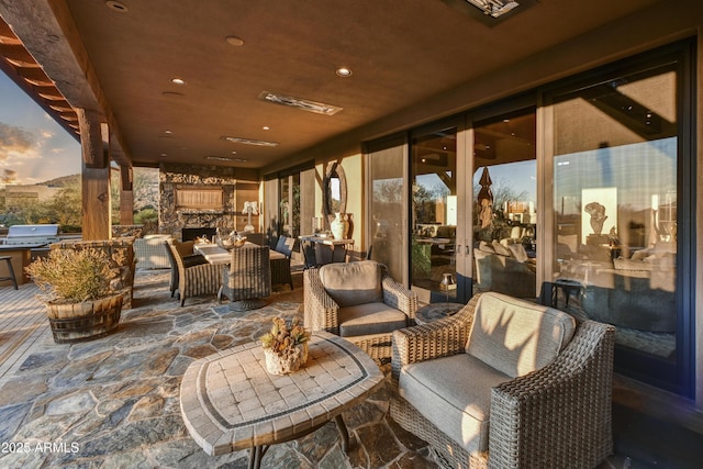 patio terrace at dusk with area for grilling and an outdoor hangout area