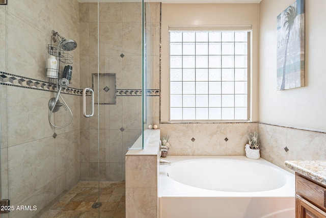 bathroom featuring vanity and shower with separate bathtub