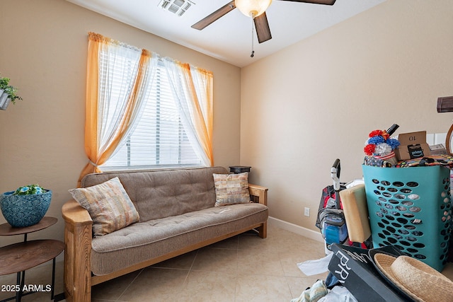 living room featuring ceiling fan and light tile patterned flooring