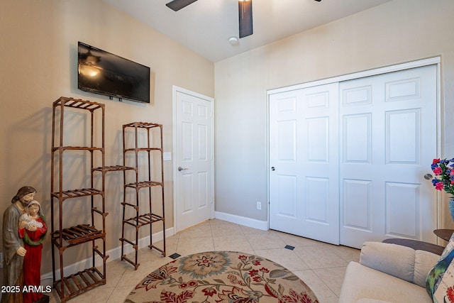 sitting room featuring light tile patterned floors and ceiling fan