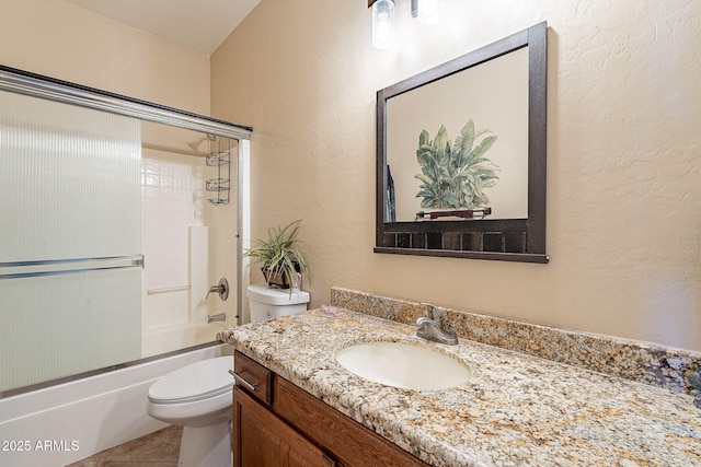 full bathroom featuring vanity, tile patterned floors, toilet, and combined bath / shower with glass door