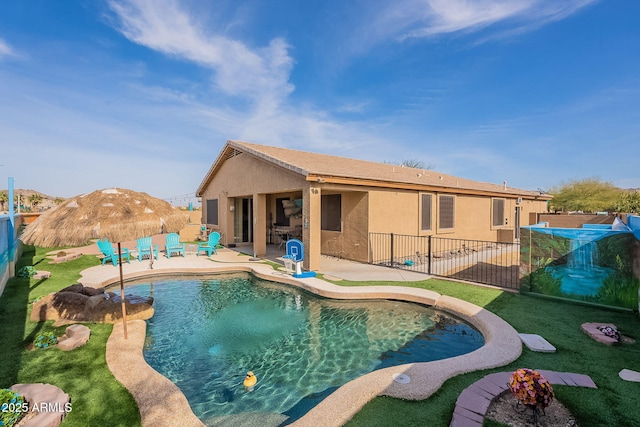 view of swimming pool featuring a yard, a mountain view, and a patio area