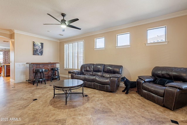 living room with ornamental molding, bar area, and ceiling fan