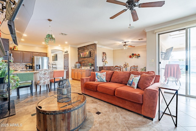 living room with crown molding and ceiling fan