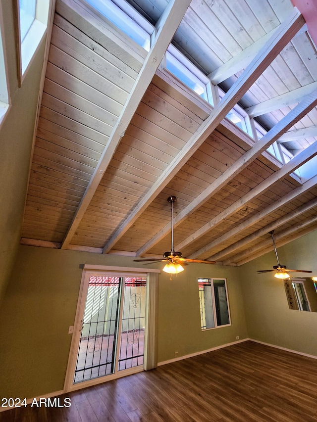 interior space with hardwood / wood-style flooring, wooden ceiling, a wealth of natural light, and vaulted ceiling with beams