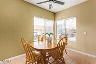 tiled dining area featuring plenty of natural light and ceiling fan