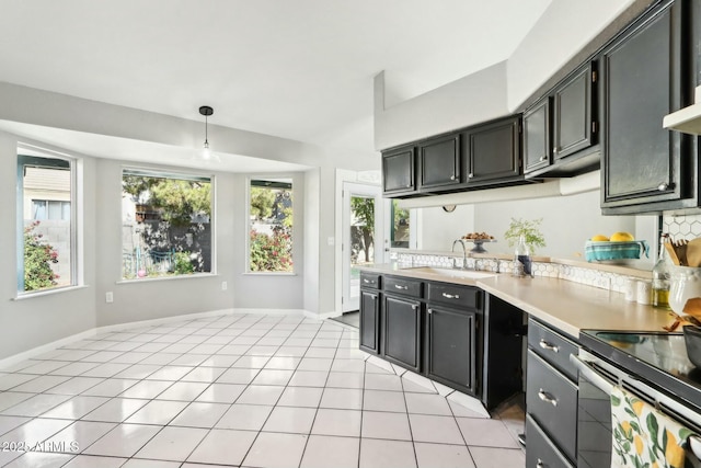 kitchen with decorative light fixtures, sink, stainless steel range with electric cooktop, and light tile patterned floors