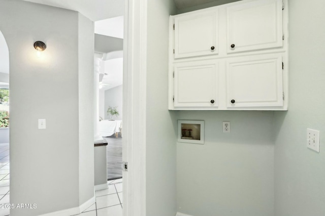 laundry room featuring cabinets, washer hookup, and light tile patterned floors