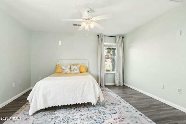 bedroom with dark wood-type flooring and ceiling fan