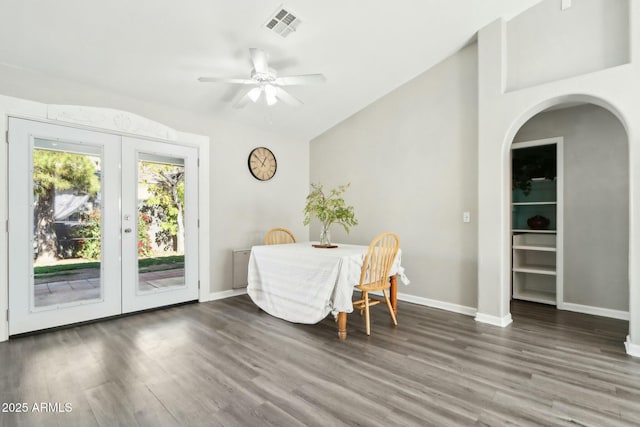 dining room with french doors, ceiling fan, lofted ceiling, and dark wood-type flooring