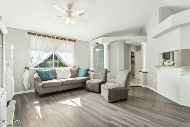 living room with dark hardwood / wood-style floors, ceiling fan, and ornate columns