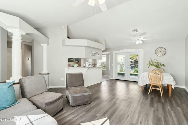 living room featuring dark hardwood / wood-style floors, decorative columns, french doors, and ceiling fan