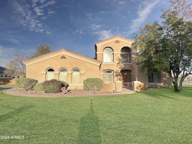 mediterranean / spanish home featuring a front yard