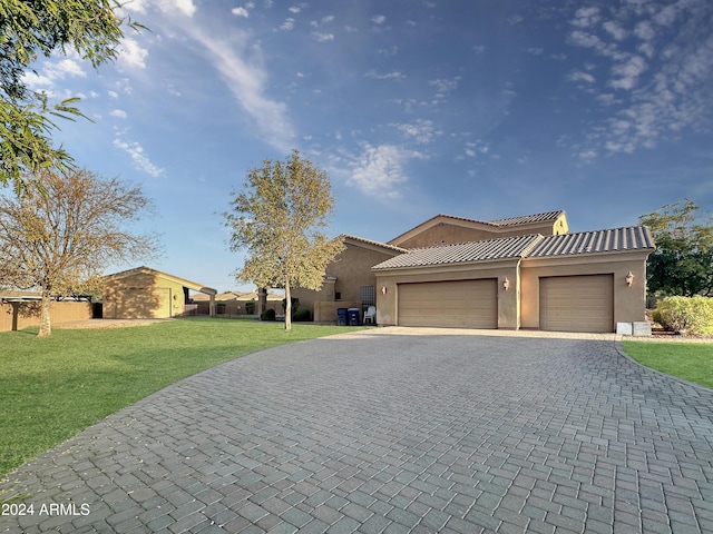 view of front of property with a front lawn and a garage