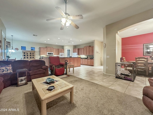 tiled living room featuring ceiling fan