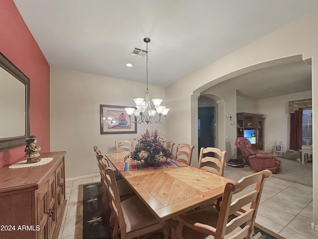 tiled dining area with a chandelier