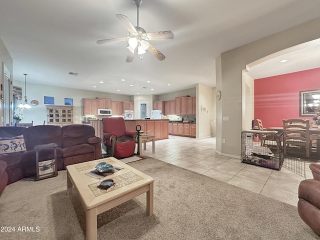 tiled living room featuring ceiling fan