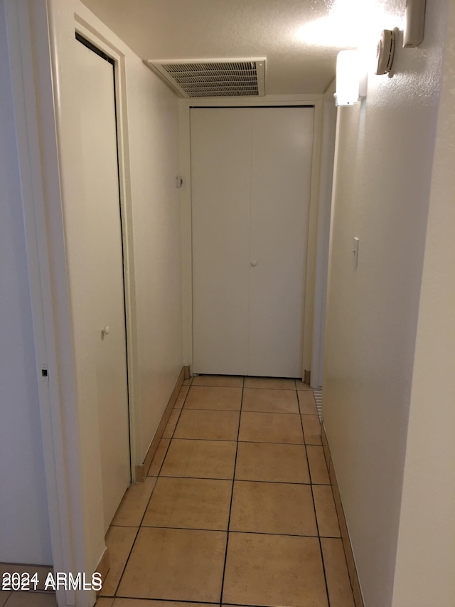 hallway with light tile patterned floors