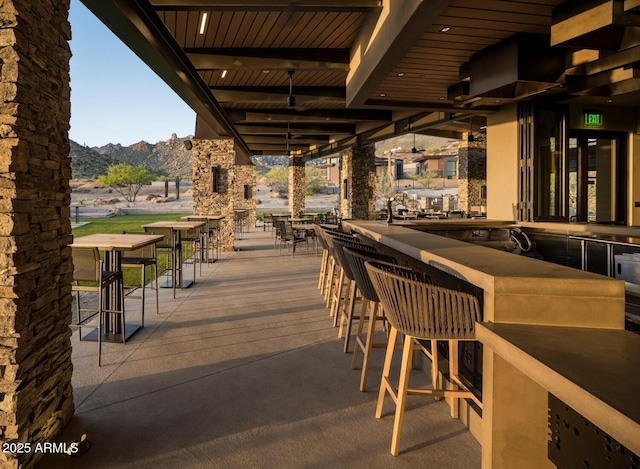 view of patio featuring a mountain view and a bar