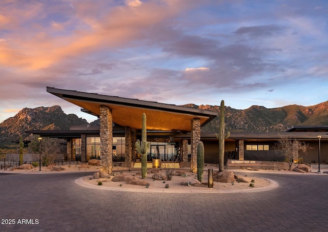 24642 N 123rd Pl Unit 114, Scottsdale, AZ 85255 - view of front of property featuring curved driveway, a mountain view, and stone siding