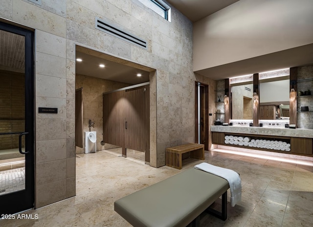 24642 N 123rd Pl Unit 114, Scottsdale, AZ 85255 - bathroom featuring vanity, a high ceiling, a bidet, and stone finish flooring
