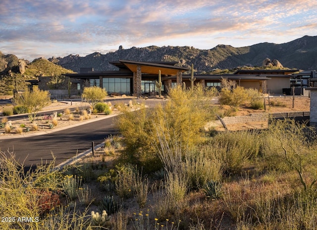 back house at dusk with a mountain view