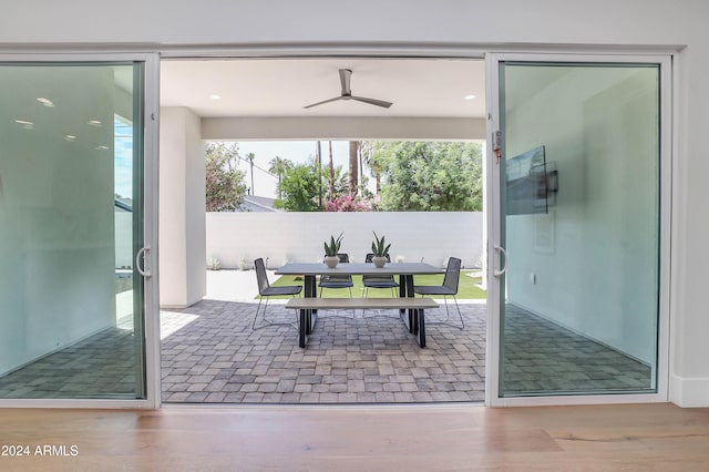 entryway with ceiling fan and wood-type flooring