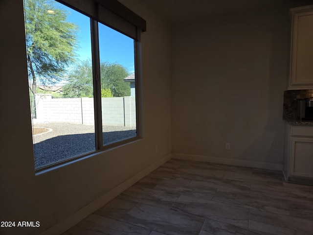 unfurnished dining area featuring a healthy amount of sunlight