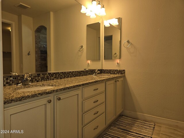 bathroom featuring vanity and tasteful backsplash