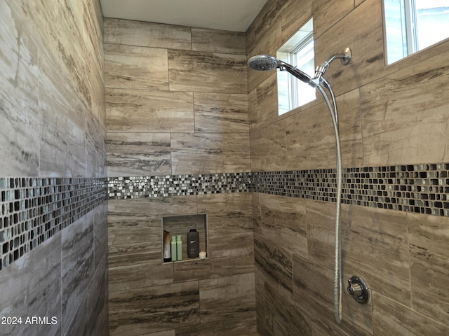 bathroom featuring a healthy amount of sunlight and a tile shower