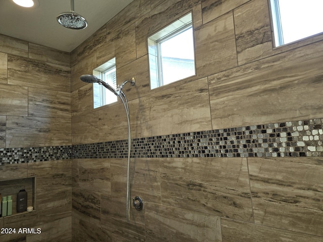 interior details featuring tiled shower