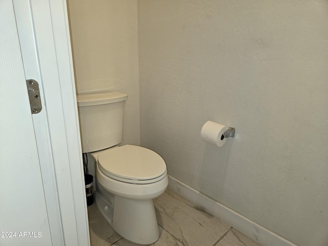 bathroom with tile patterned floors and toilet