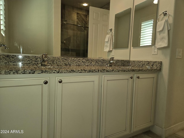 bathroom with vanity and an enclosed shower