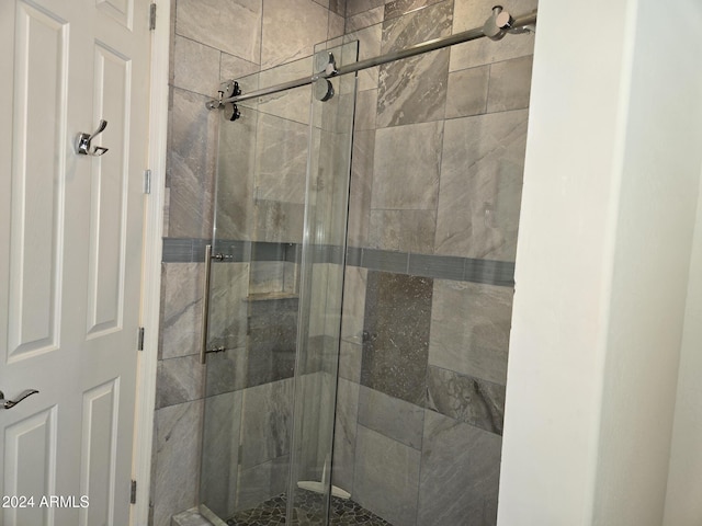 bathroom featuring a shower with door