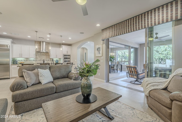 tiled living room featuring ceiling fan