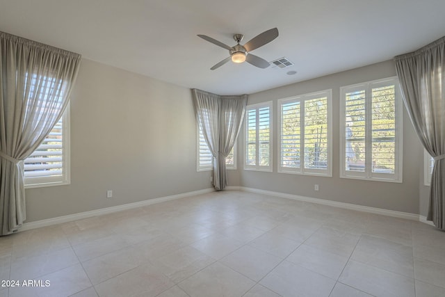 unfurnished room featuring light tile patterned floors and ceiling fan