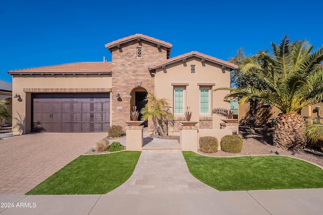 mediterranean / spanish-style house with a garage