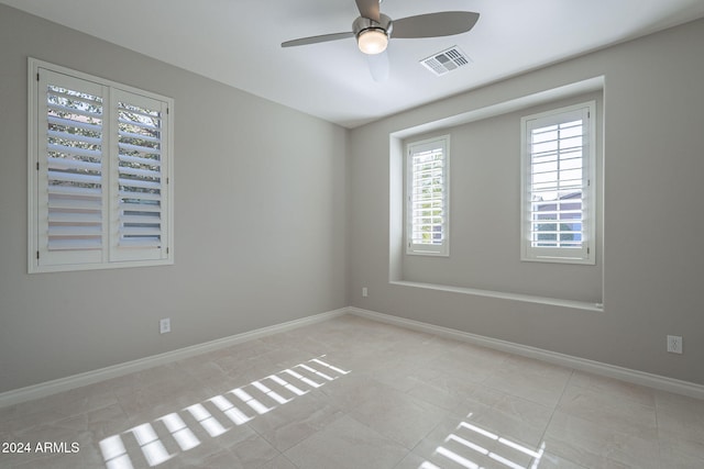 spare room featuring light tile patterned flooring and ceiling fan