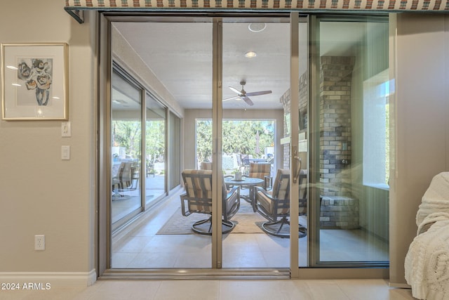 doorway to outside with a wealth of natural light, tile patterned floors, and ceiling fan